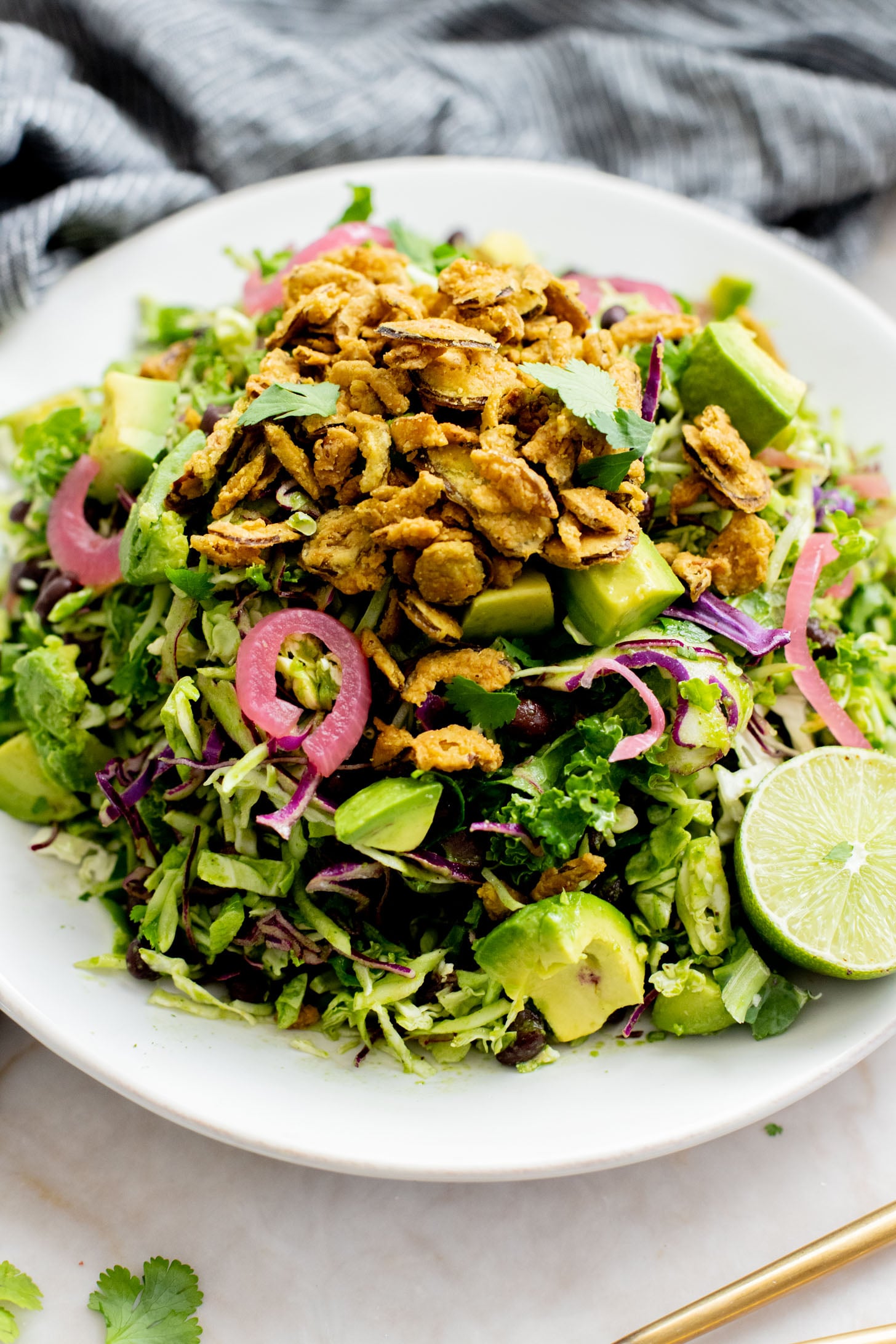 This Trader Joe's Black Bean Crunch Salad is a flavor bomb. Crisp kale slaw, black beans, crunchy jalapeños, pickled onions & a delicious cilantro lime dressing | ThisSavoryVegan.com