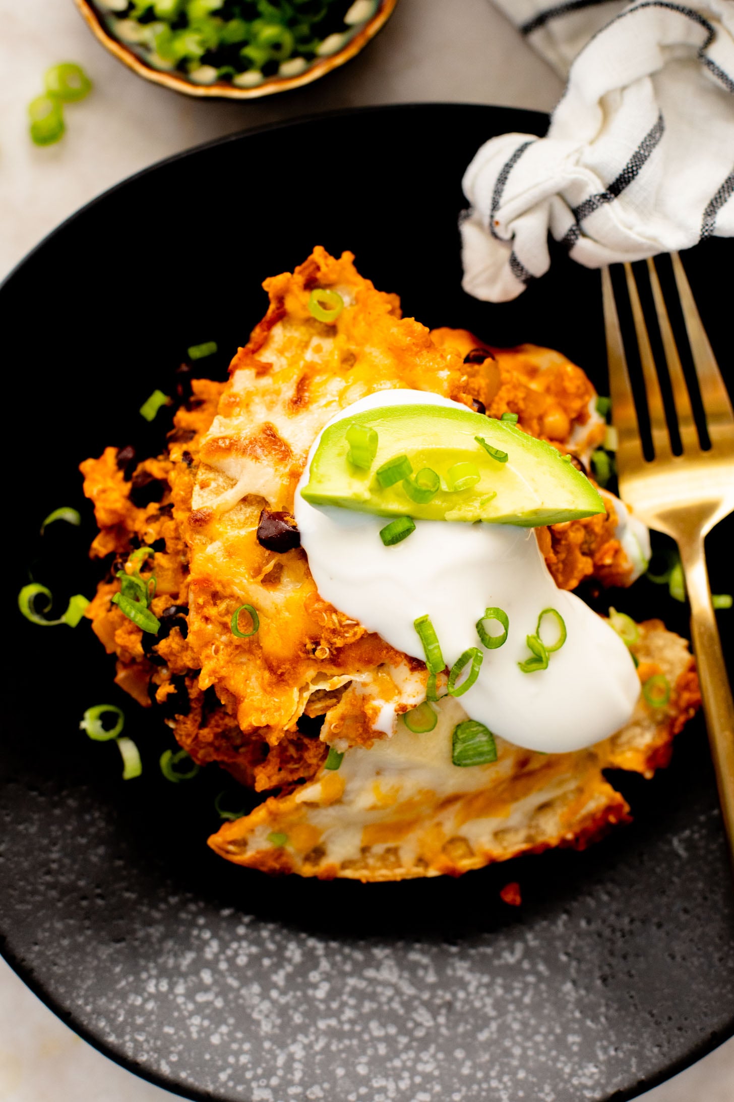 This High Protein Quinoa Enchilada Casserole is perfect for meal prep! Everything is cooked in one pot and each serving has 20+ grams of plant protein | ThisSavoryVegan.com