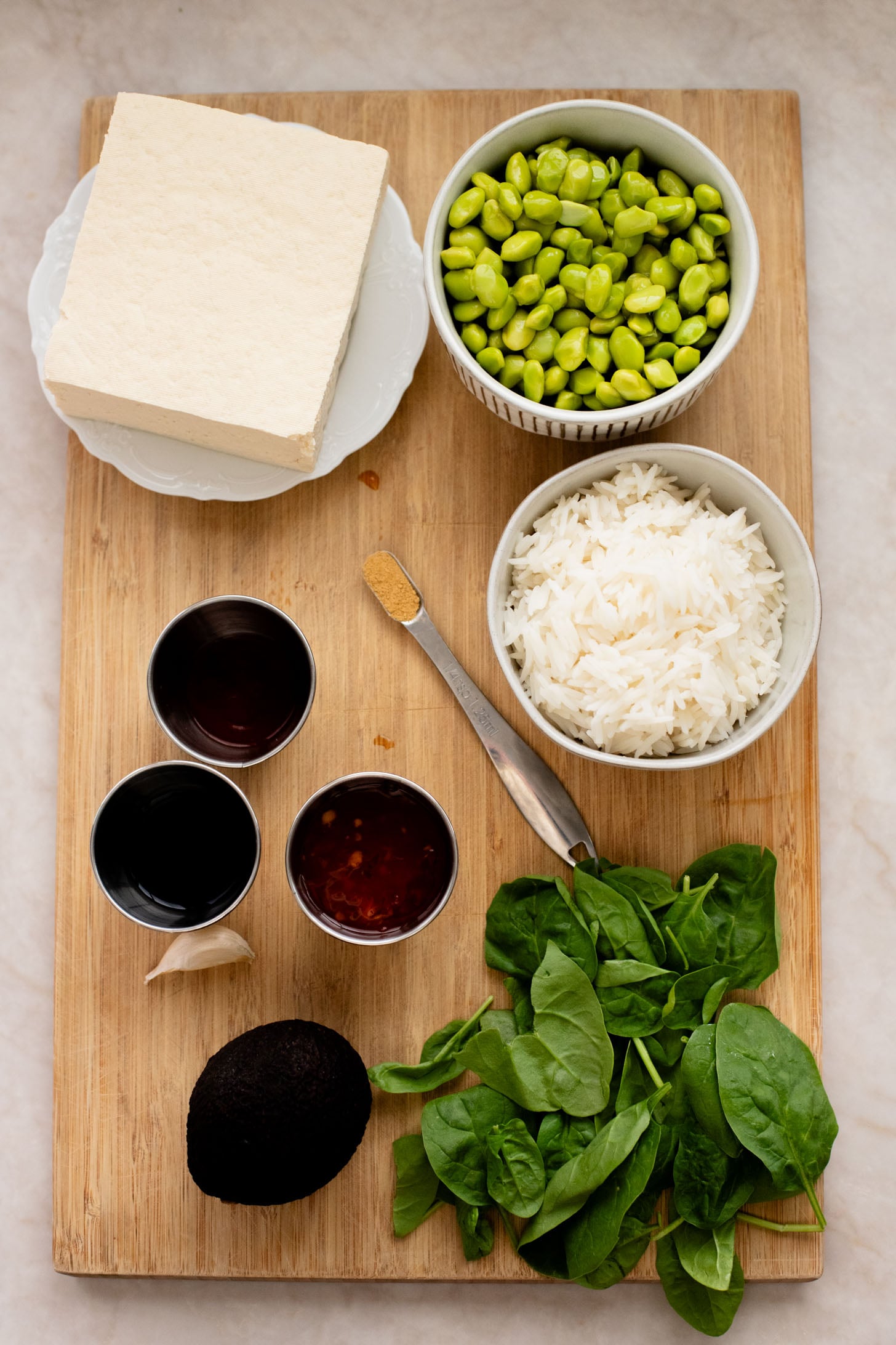 These Sweet Chili Tofu Bowls are loaded with crispy tofu, edamame, rice, avocado, greens & a spicy vegan mayo | ThisSavoryVegan.com