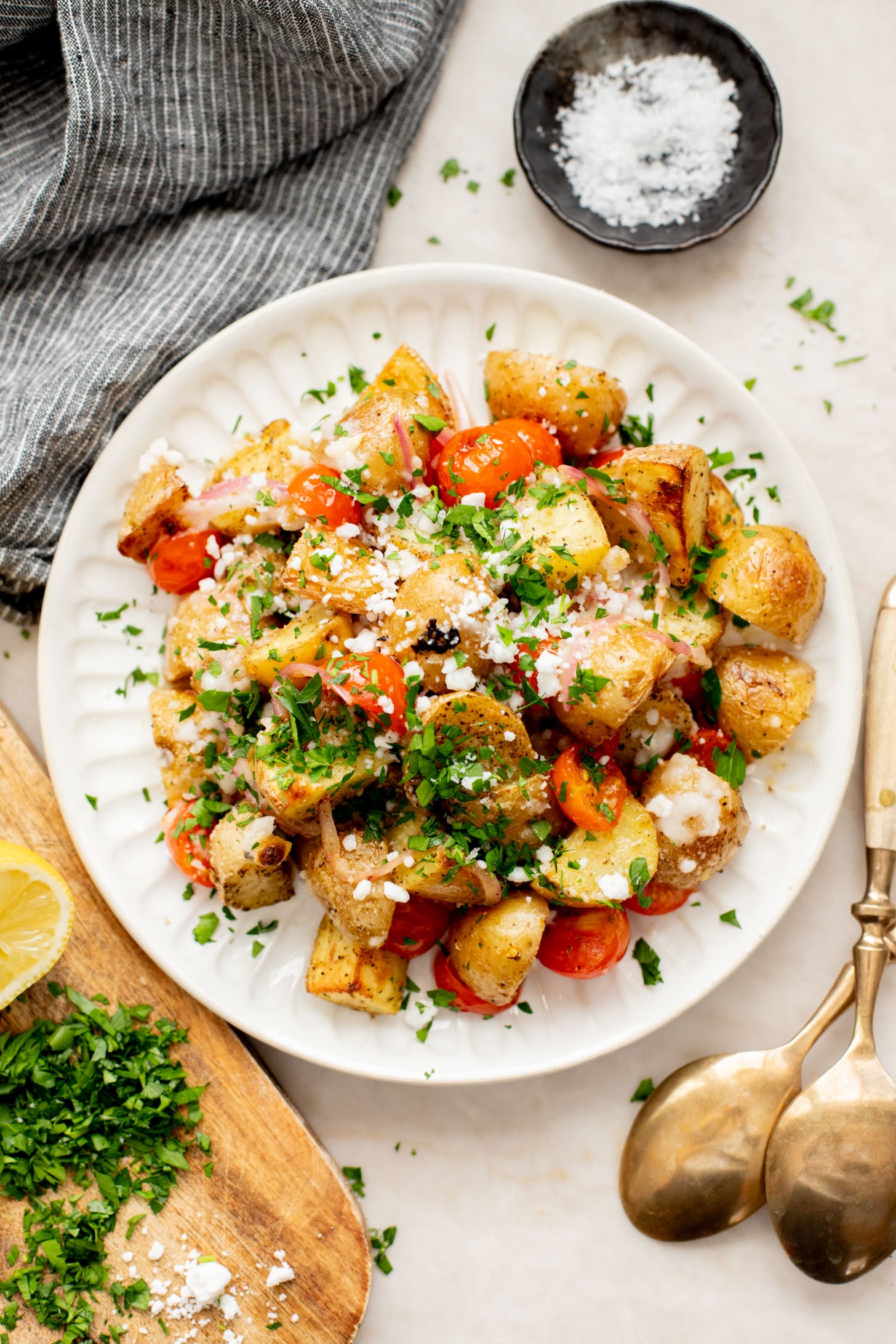 These Vegan Feta Potatoes are roasted to perfection with cherry tomatoes and topped with vegan feta, fresh herbs & lemon juice | ThisSavoryVegan.com
