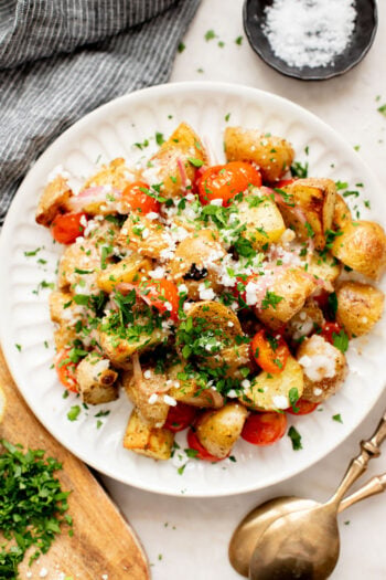 These Vegan Feta Potatoes are roasted to perfection with cherry tomatoes and topped with vegan feta, fresh herbs & lemon juice | ThisSavoryVegan.com