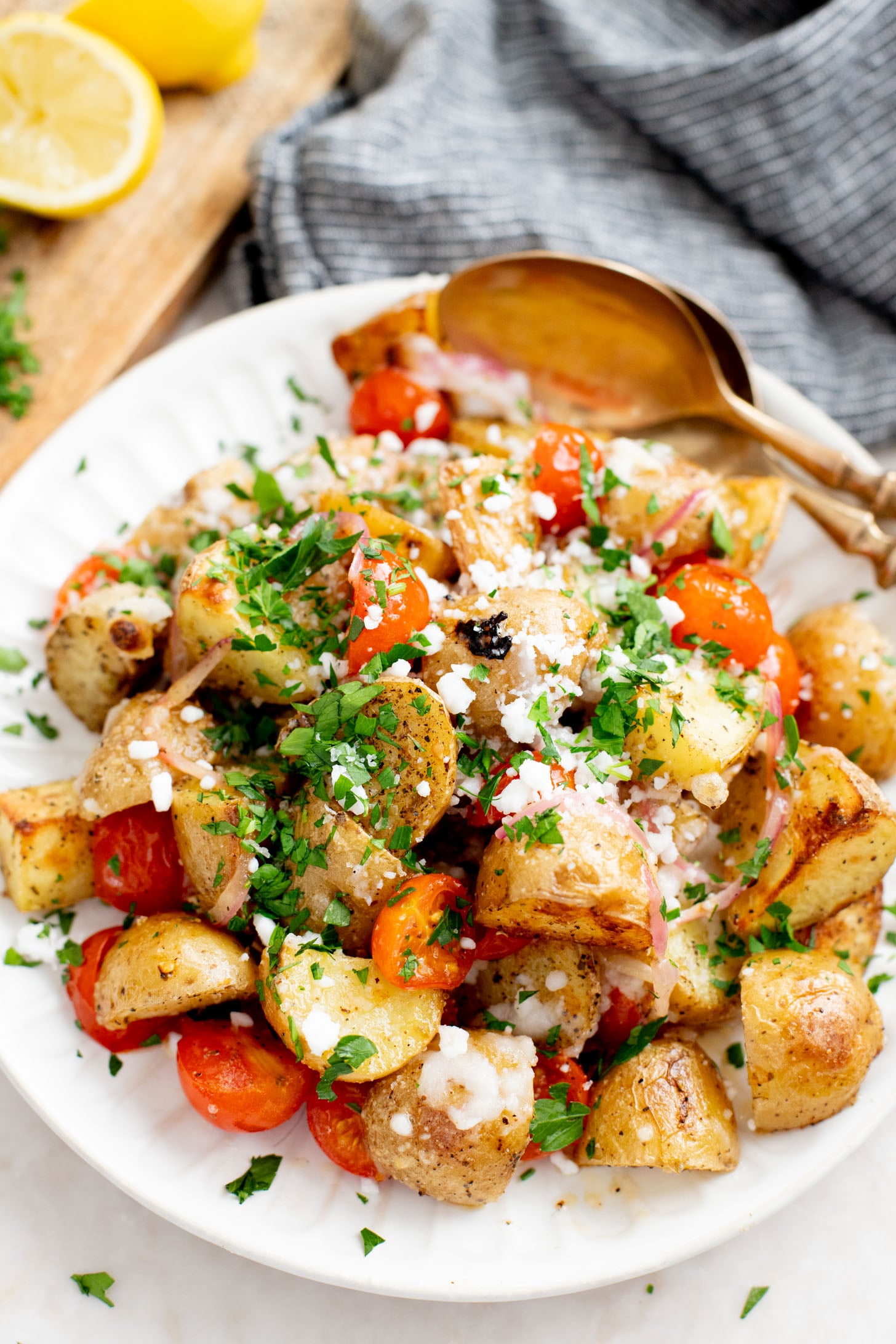 These Vegan Feta Potatoes are roasted to perfection with cherry tomatoes and topped with vegan feta, fresh herbs & lemon juice | ThisSavoryVegan.com