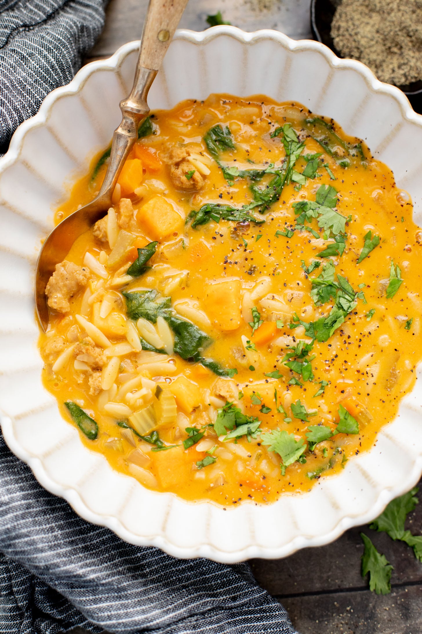 This Buffalo Sweet Potato Orzo Soup is comfort in a bowl. Made with vegan sausage, tender sweet potatoes and the perfect amount of spice | ThisSavoryVegan.com