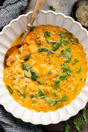 This Buffalo Sweet Potato Orzo Soup is comfort in a bowl. Made with vegan sausage, tender sweet potatoes and the perfect amount of spice | ThisSavoryVegan.com
