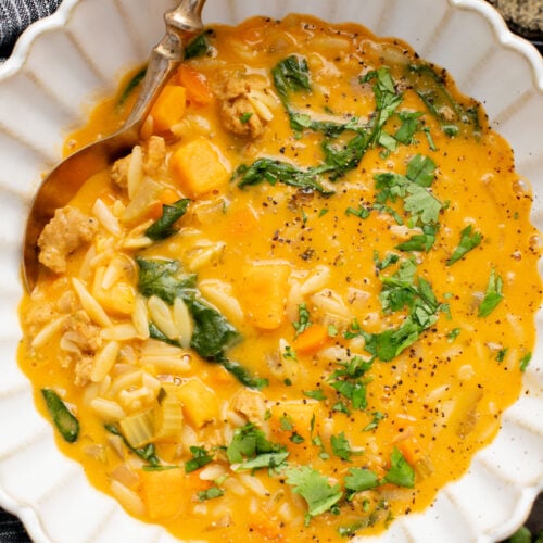 This Buffalo Sweet Potato Orzo Soup is comfort in a bowl. Made with vegan sausage, tender sweet potatoes and the perfect amount of spice | ThisSavoryVegan.com