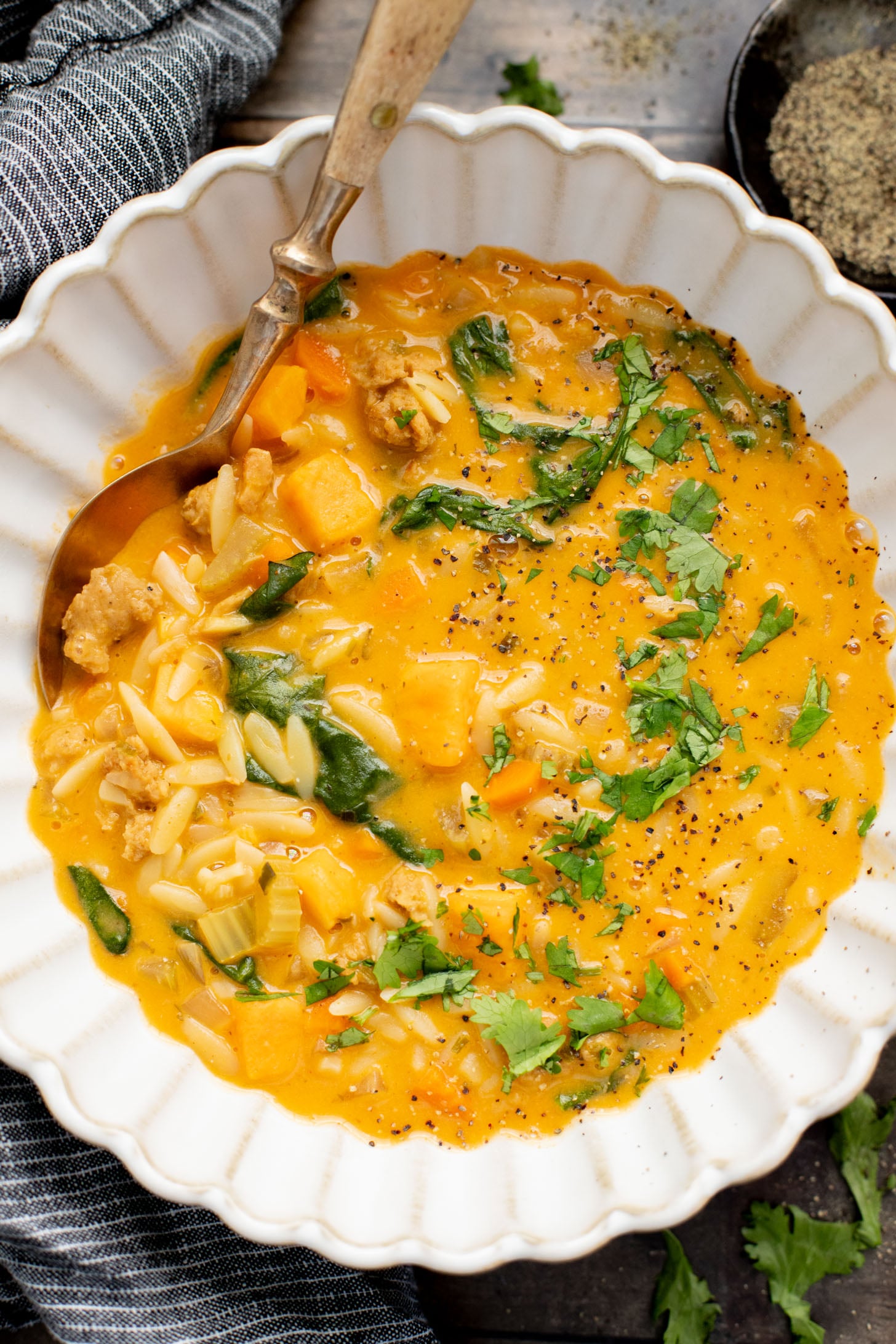 This Buffalo Sweet Potato Orzo Soup is comfort in a bowl. Made with vegan sausage, tender sweet potatoes and the perfect amount of spice | ThisSavoryVegan.com