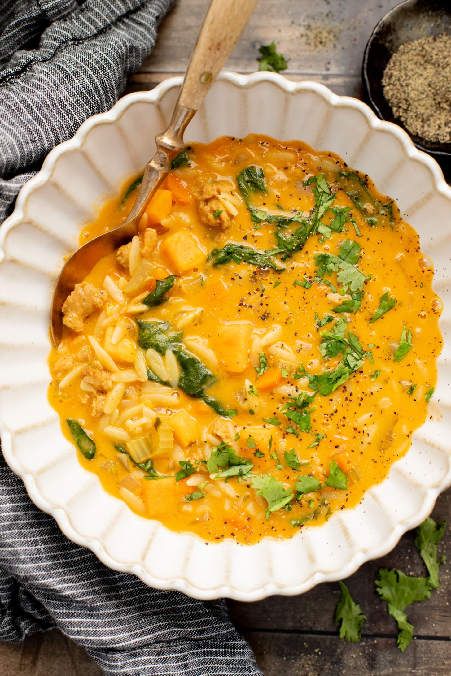 This Buffalo Sweet Potato Orzo Soup is comfort in a bowl. Made with vegan sausage, tender sweet potatoes and the perfect amount of spice | ThisSavoryVegan.com