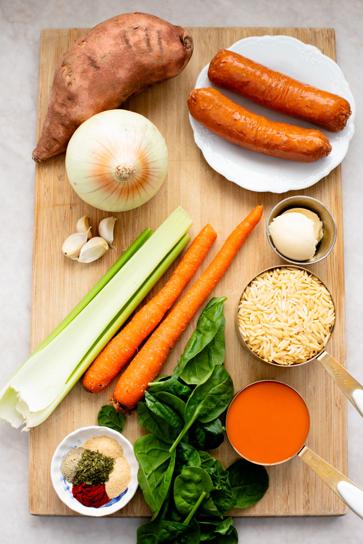 This Buffalo Sweet Potato Orzo Soup is comfort in a bowl. Made with vegan sausage, tender sweet potatoes and the perfect amount of spice | ThisSavoryVegan.com