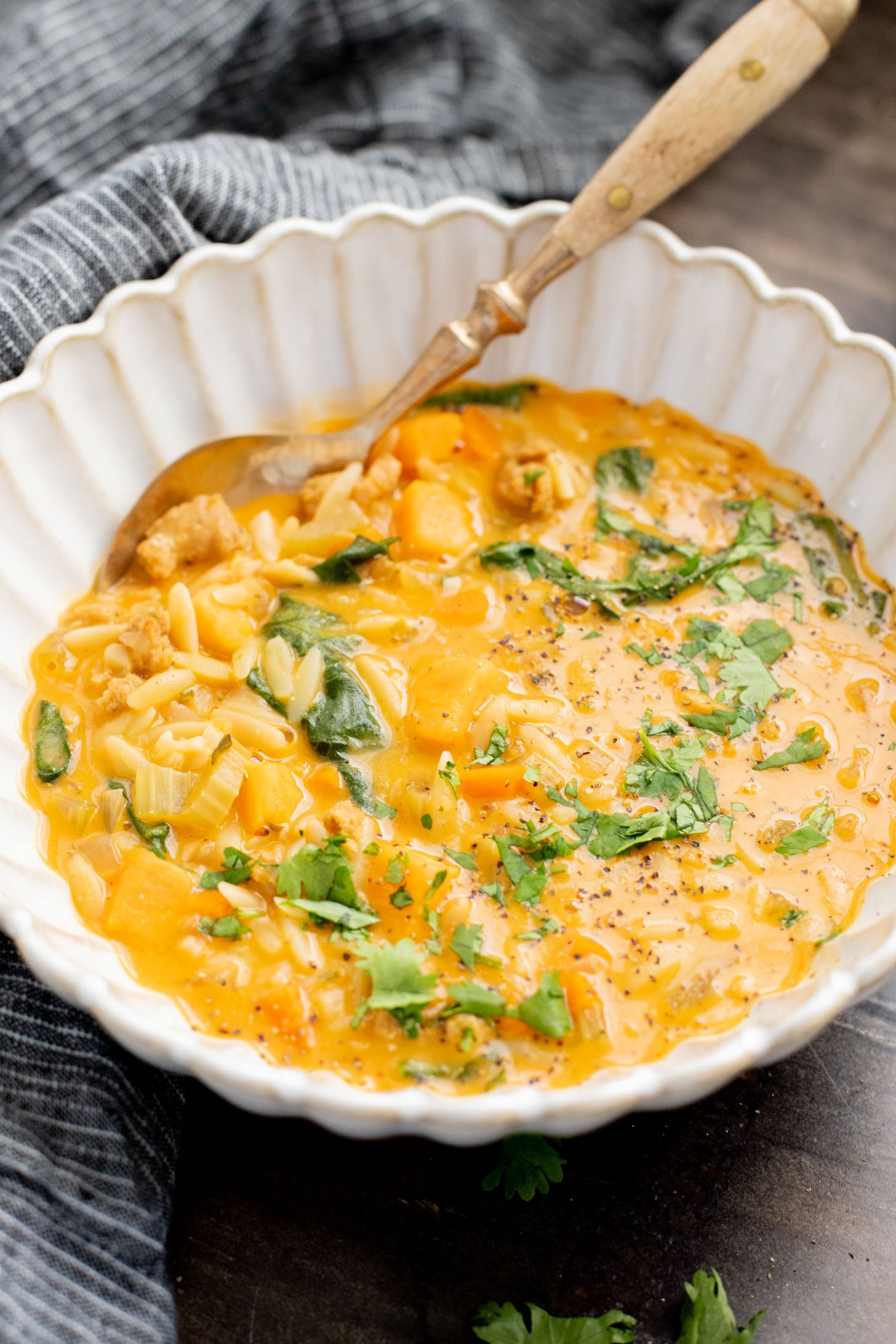 This Buffalo Sweet Potato Orzo Soup is comfort in a bowl. Made with vegan sausage, tender sweet potatoes and the perfect amount of spice | ThisSavoryVegan.com