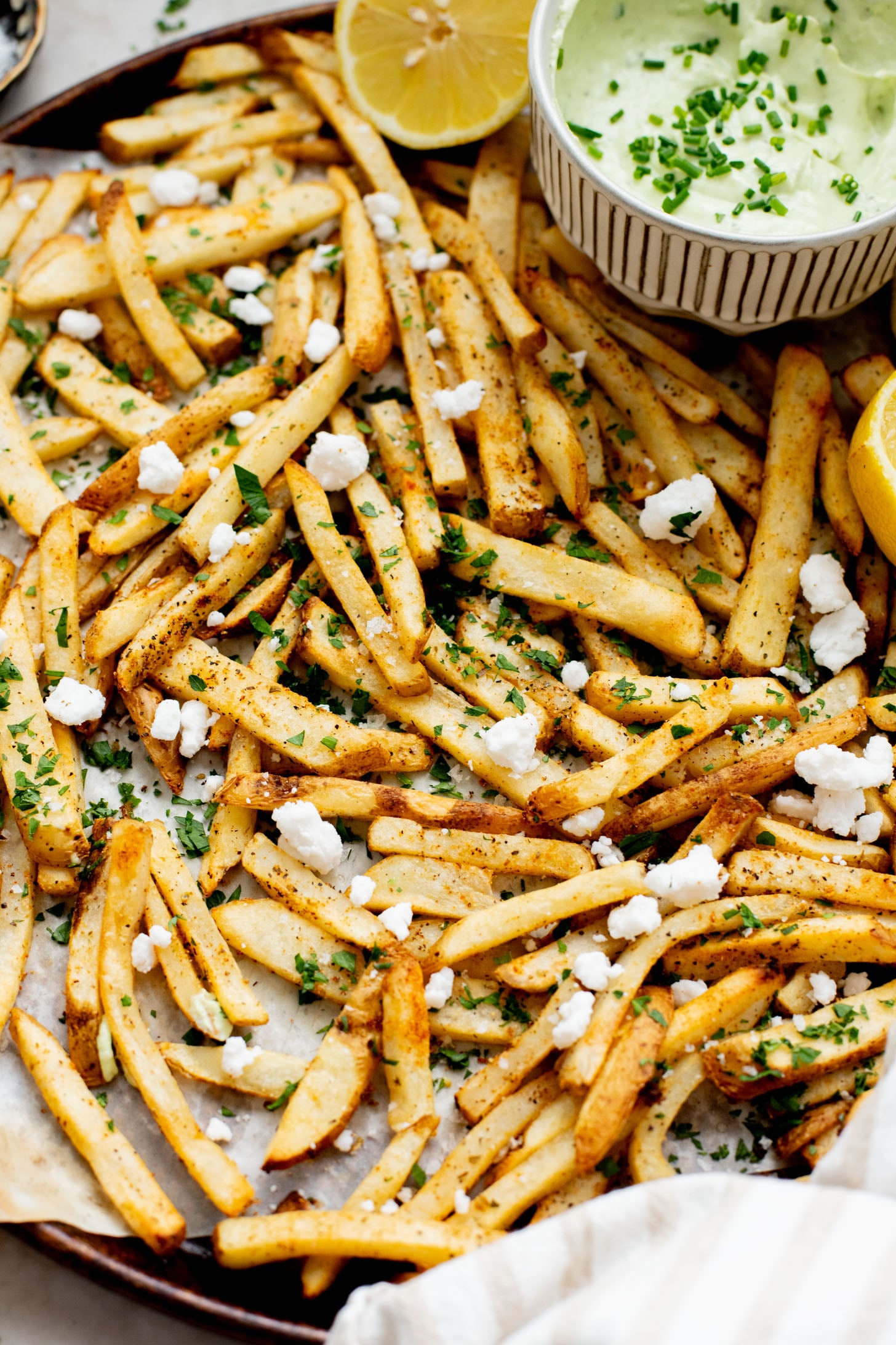 These Seasoned Fries with Feta Chive Dip is the ultimate vegan party snack. Frozen fries are seasoned and then served with the BEST vegan chive dip | ThisSavoryVegan.com