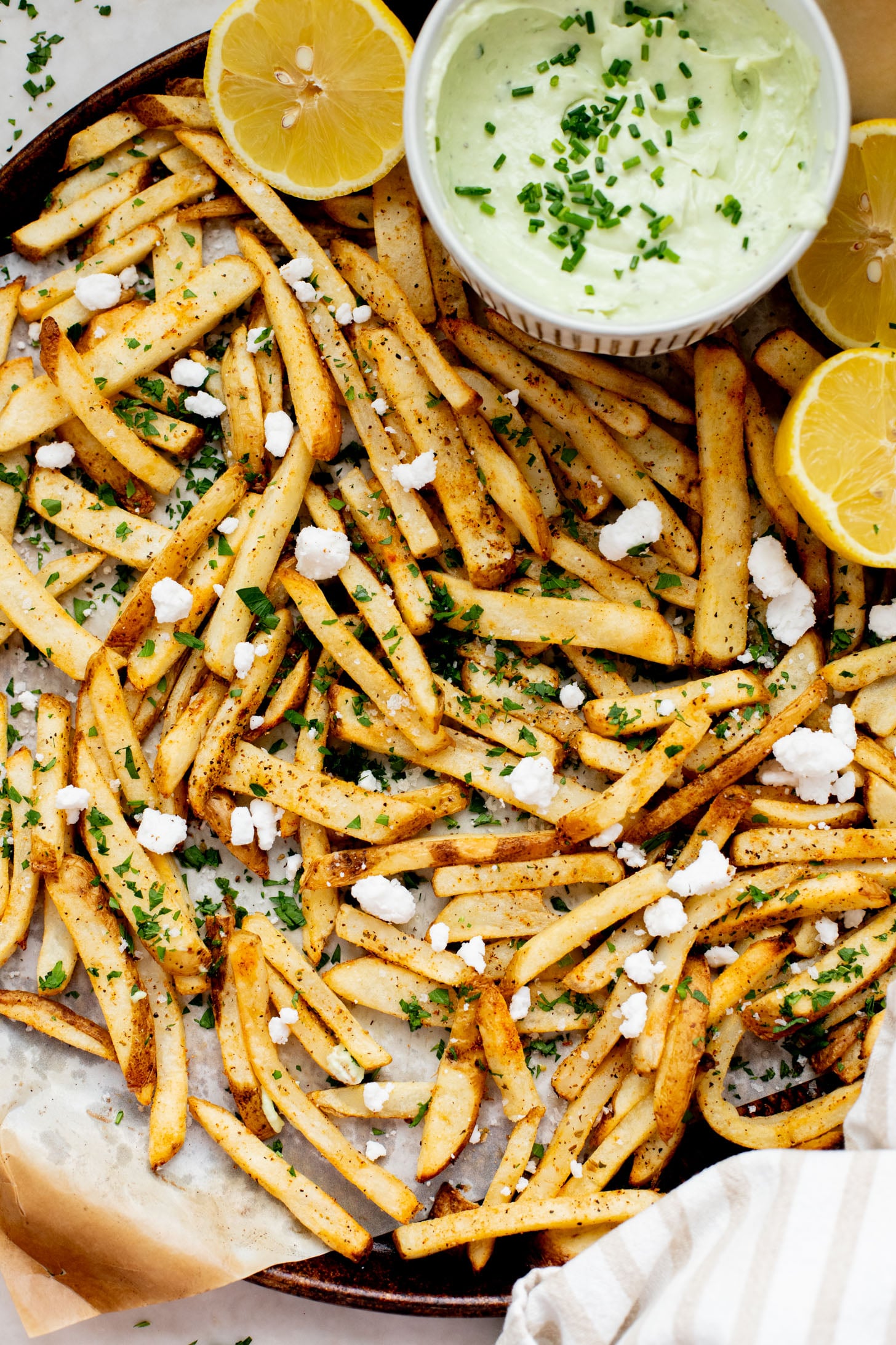 These Seasoned Fries with Feta Chive Dip is the ultimate vegan party snack. Frozen fries are seasoned and then served with the BEST vegan chive dip | ThisSavoryVegan.com