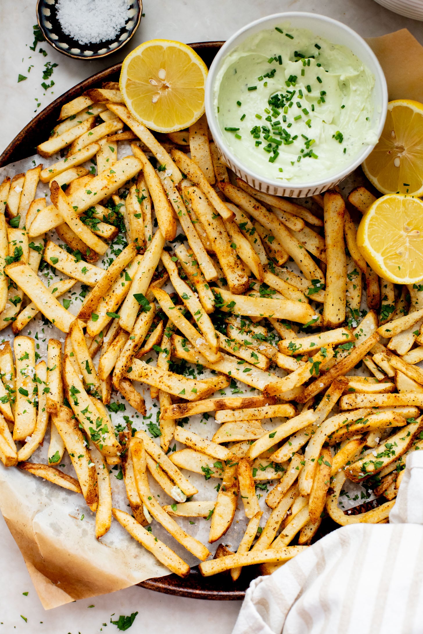 These Seasoned Fries with Feta Chive Dip is the ultimate vegan party snack. Frozen fries are seasoned and then served with the BEST vegan chive dip | ThisSavoryVegan.com