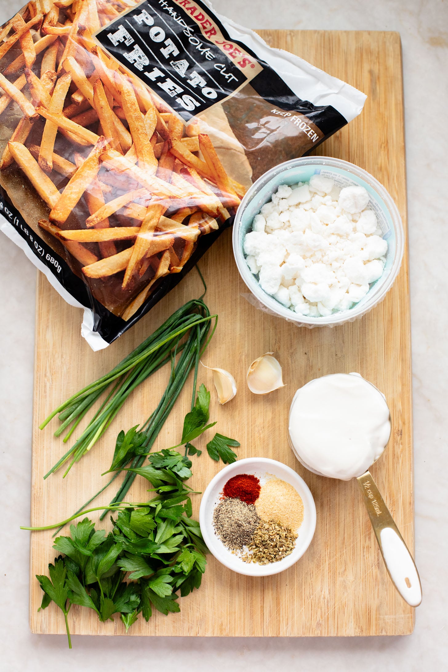 These Seasoned Fries with Feta Chive Dip is the ultimate vegan party snack. Frozen fries are seasoned and then served with the BEST vegan chive dip | ThisSavoryVegan.com
