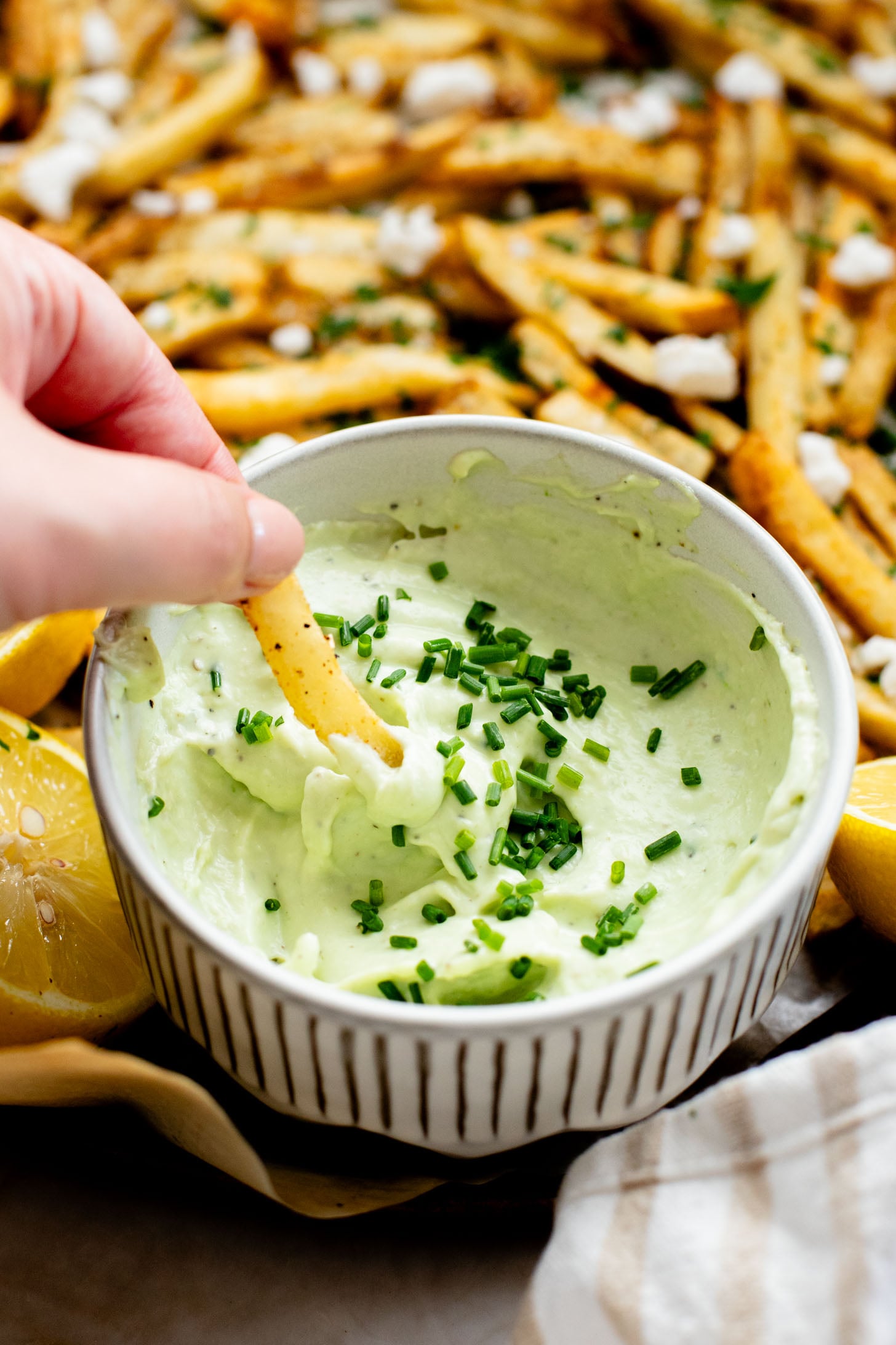 These Seasoned Fries with Feta Chive Dip is the ultimate vegan party snack. Frozen fries are seasoned and then served with the BEST vegan chive dip | ThisSavoryVegan.com