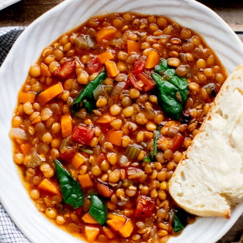 This Slow Cooker Lentil & Veggie Soup is hearty, easy and delicious. Packed with veggies & simmered all day in the most delicious vegan broth | ThisSavoryVegan.com
