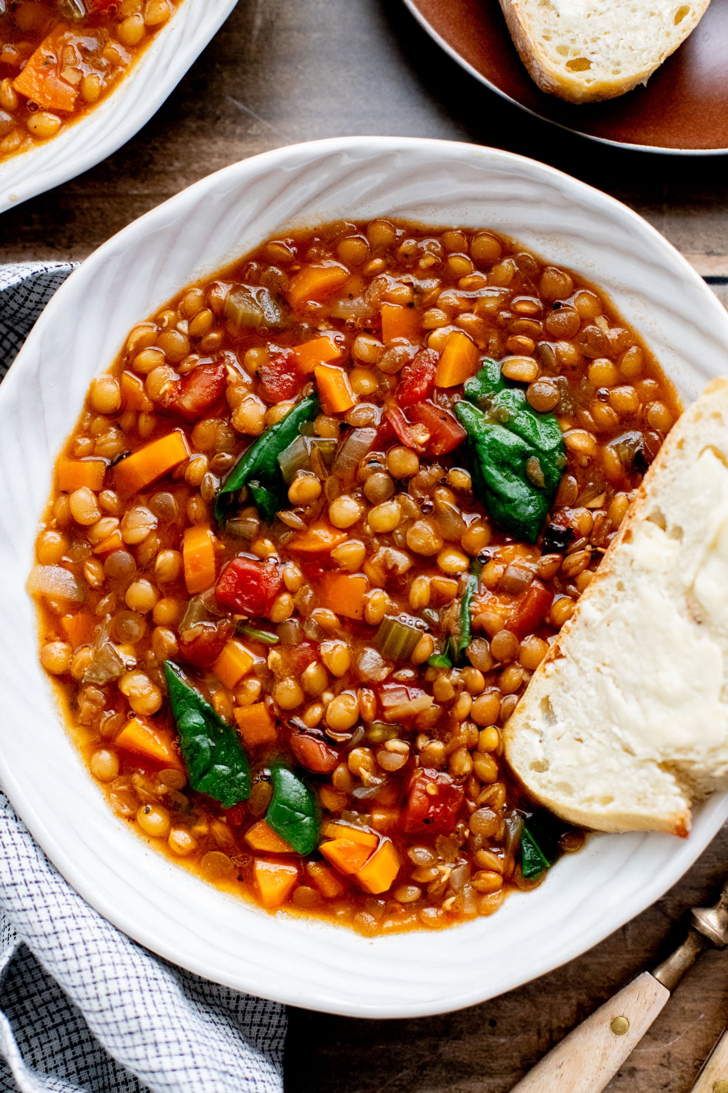 This Slow Cooker Lentil & Veggie Soup is hearty, easy and delicious. Packed with veggies & simmered all day in the most delicious vegan broth | ThisSavoryVegan.com