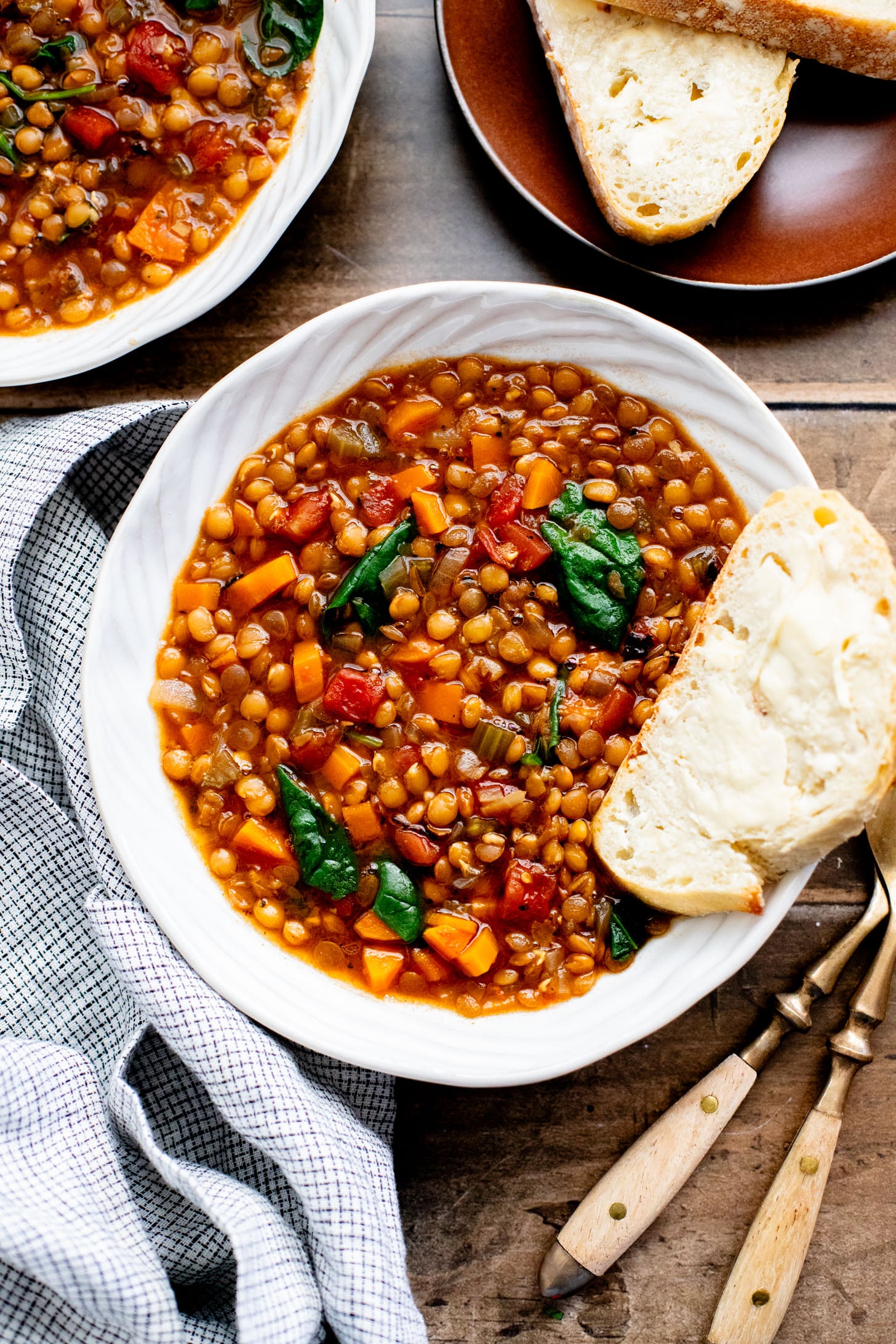 This Slow Cooker Lentil & Veggie Soup is hearty, easy and delicious. Packed with veggies & simmered all day in the most delicious vegan broth | ThisSavoryVegan.com
