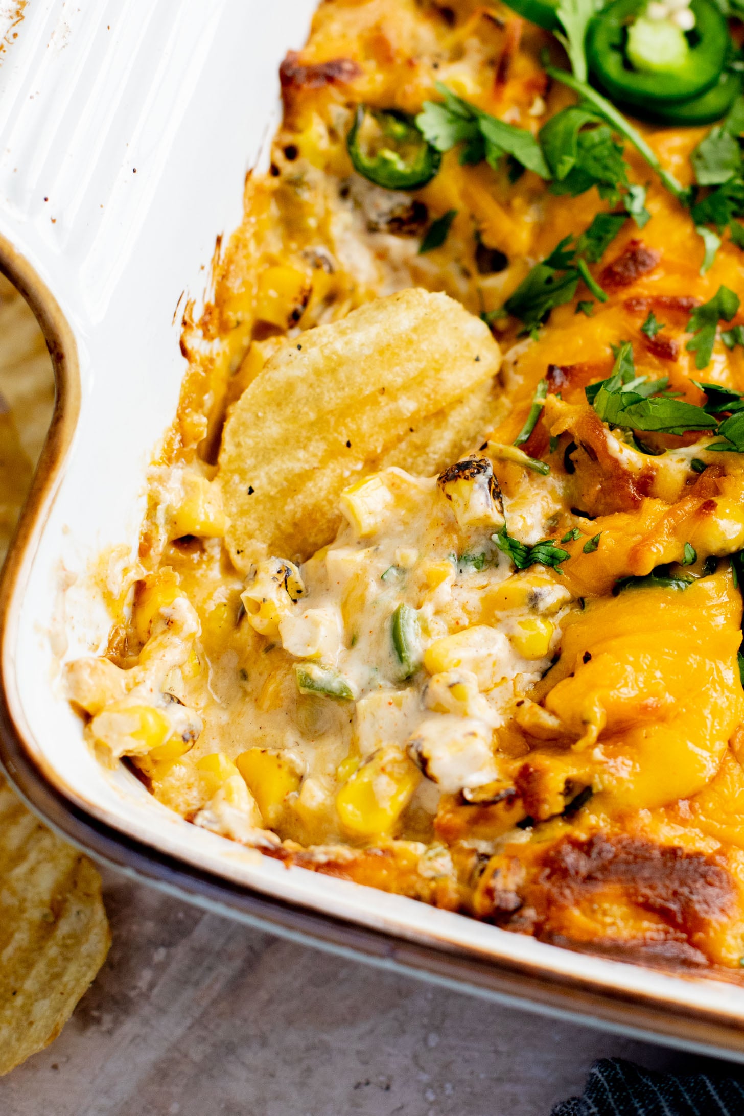 This Spicy Cheesy Corn Dip is the perfect dairy-free game day snack! Creamy, delicious and has the perfect kick. Great with chips | ThisSavoryVegan.com