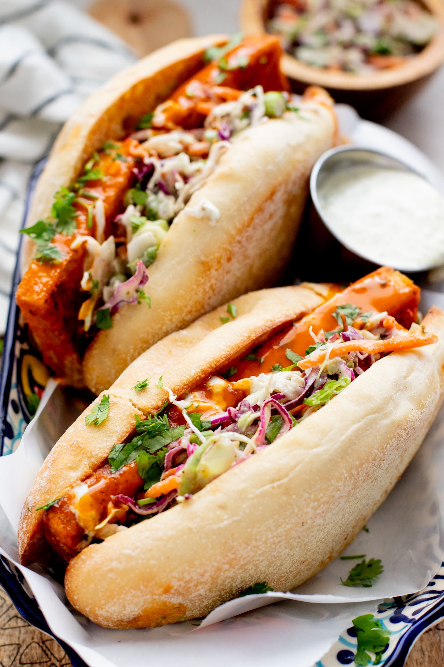 These Trader Joe's Buffalo Tofu Sandwiches are filled with crispy buffalo tofu and the most delicious vegan slaw! The perfect vegan sammie | ThisSavoryVegan.com