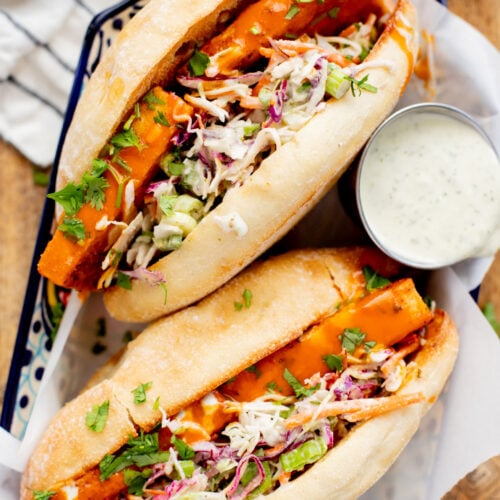 These Trader Joe's Buffalo Tofu Sandwiches are filled with crispy buffalo tofu and the most delicious vegan slaw! The perfect vegan sammie | ThisSavoryVegan.com