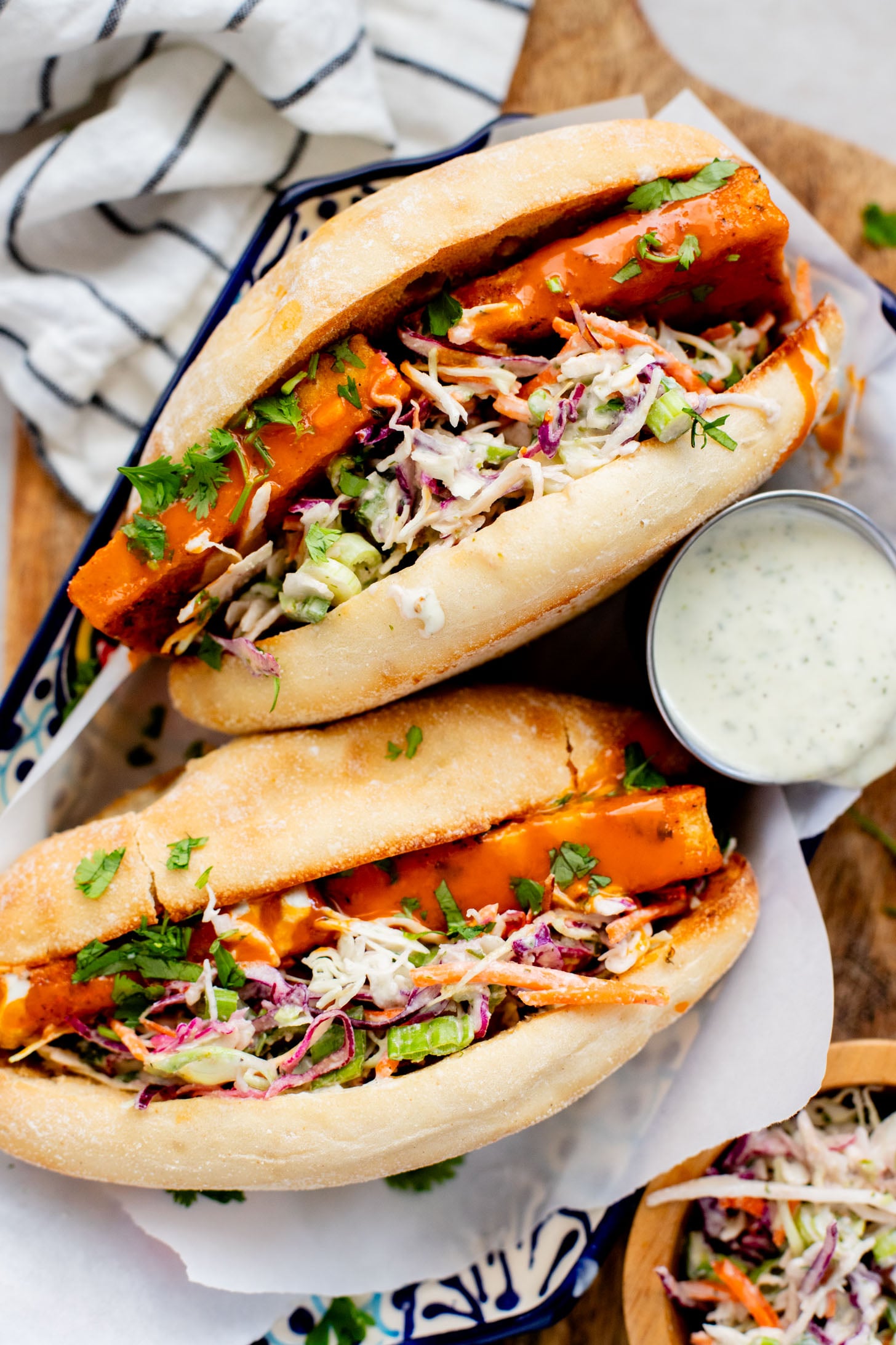 These Trader Joe's Buffalo Tofu Sandwiches are filled with crispy buffalo tofu and the most delicious vegan slaw! The perfect vegan sammie | ThisSavoryVegan.com