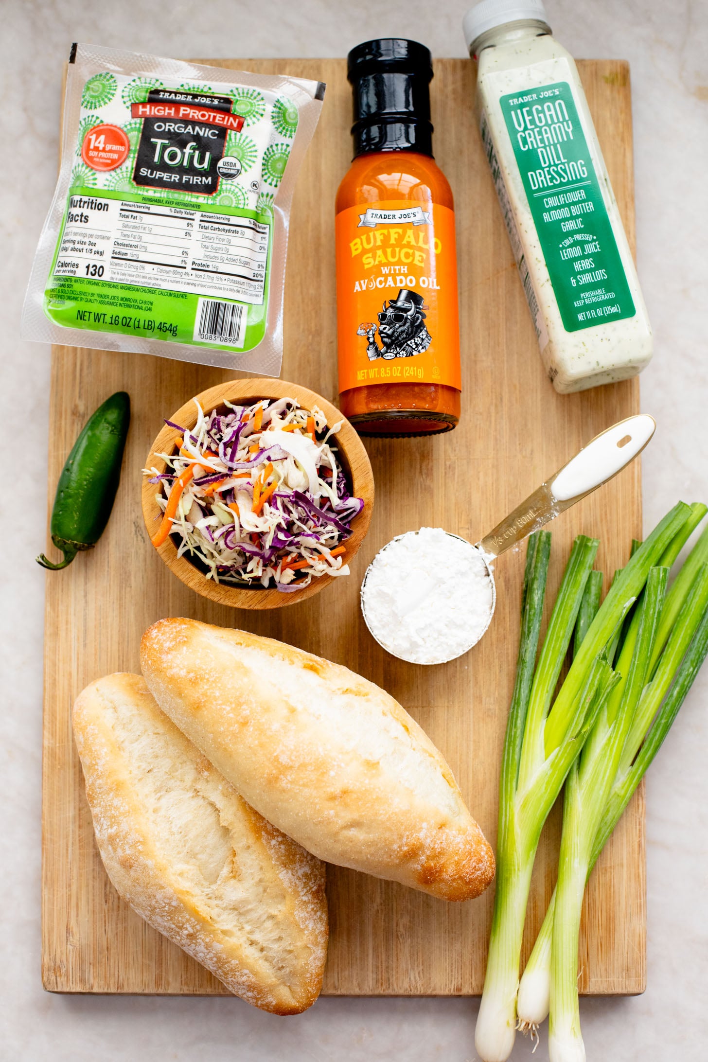 These Trader Joe's Buffalo Tofu Sandwiches are filled with crispy buffalo tofu and the most delicious vegan slaw! The perfect vegan sammie | ThisSavoryVegan.com
