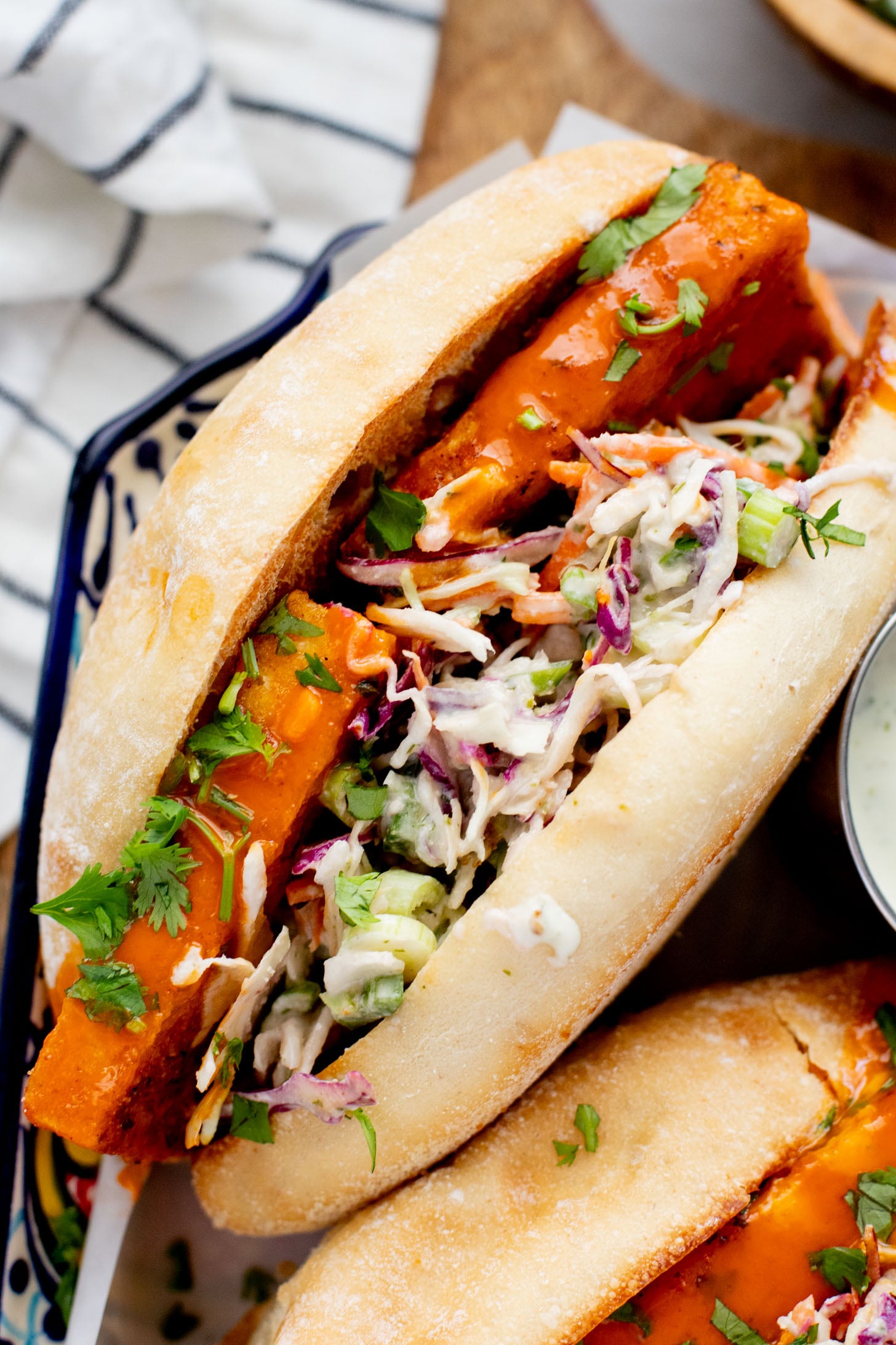 These Trader Joe's Buffalo Tofu Sandwiches are filled with crispy buffalo tofu and the most delicious vegan slaw! The perfect vegan sammie | ThisSavoryVegan.com