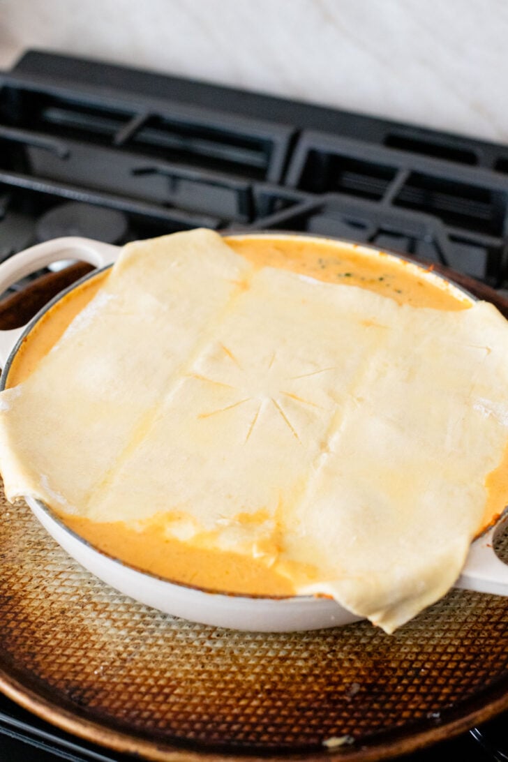 This Red Curry Butternut Squash Pot Pie is veggie-packed comfort food. Tender veggies, chickpeas and a delicious coconut curry sauce | ThisSavoryVegan.com