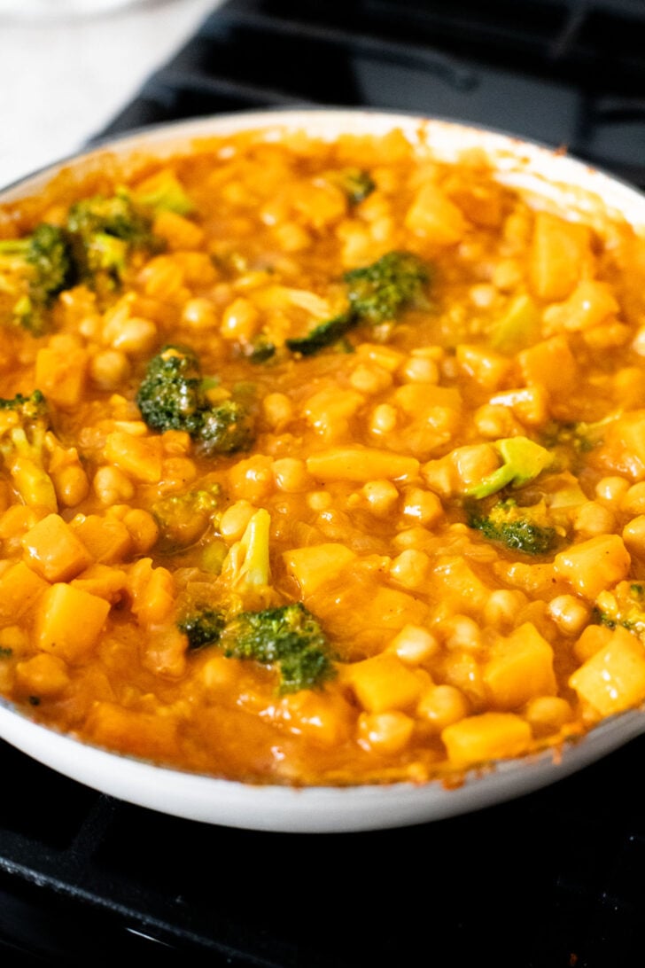 This Red Curry Butternut Squash Pot Pie is veggie-packed comfort food. Tender veggies, chickpeas and a delicious coconut curry sauce | ThisSavoryVegan.com