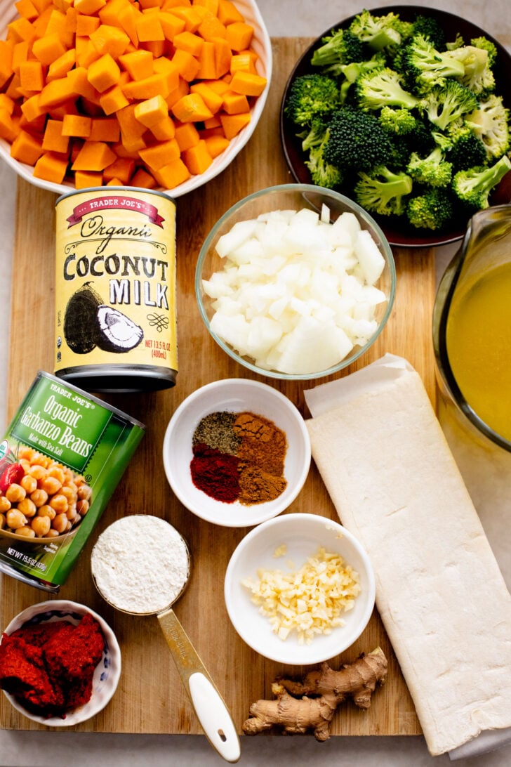 This Red Curry Butternut Squash Pot Pie is veggie-packed comfort food. Tender veggies, chickpeas and a delicious coconut curry sauce | ThisSavoryVegan.com