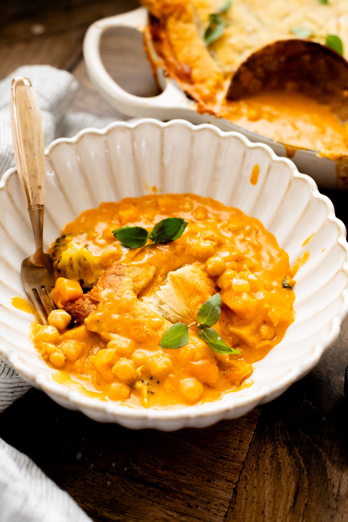 This Red Curry Butternut Squash Pot Pie is veggie-packed comfort food. Tender veggies, chickpeas and a delicious coconut curry sauce | ThisSavoryVegan.com