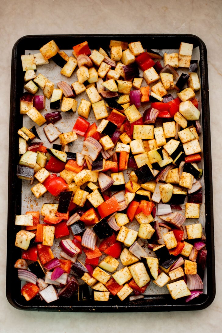 This Roasted Veggie Lentil Salad is filled with eggplant, bell pepper, onions, fresh herbs, lentils, vegan feta & a light, tangy dressing | ThisSavoryVegan.com