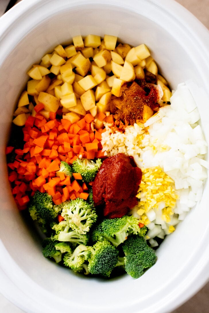 This Slow Cooker Red Curry Potato Soup is packed with veggies and the most delicious coconut broth. The perfect dairy-free soup | ThisSavoryVegan.com