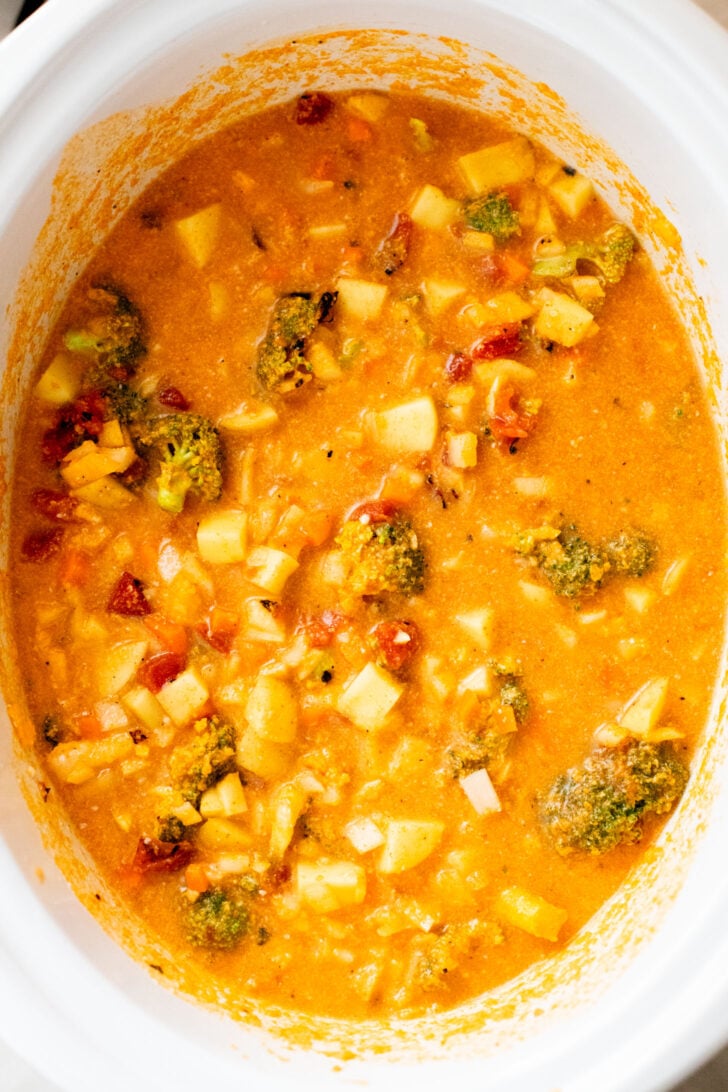 This Slow Cooker Red Curry Potato Soup is packed with veggies and the most delicious coconut broth. The perfect dairy-free soup | ThisSavoryVegan.com