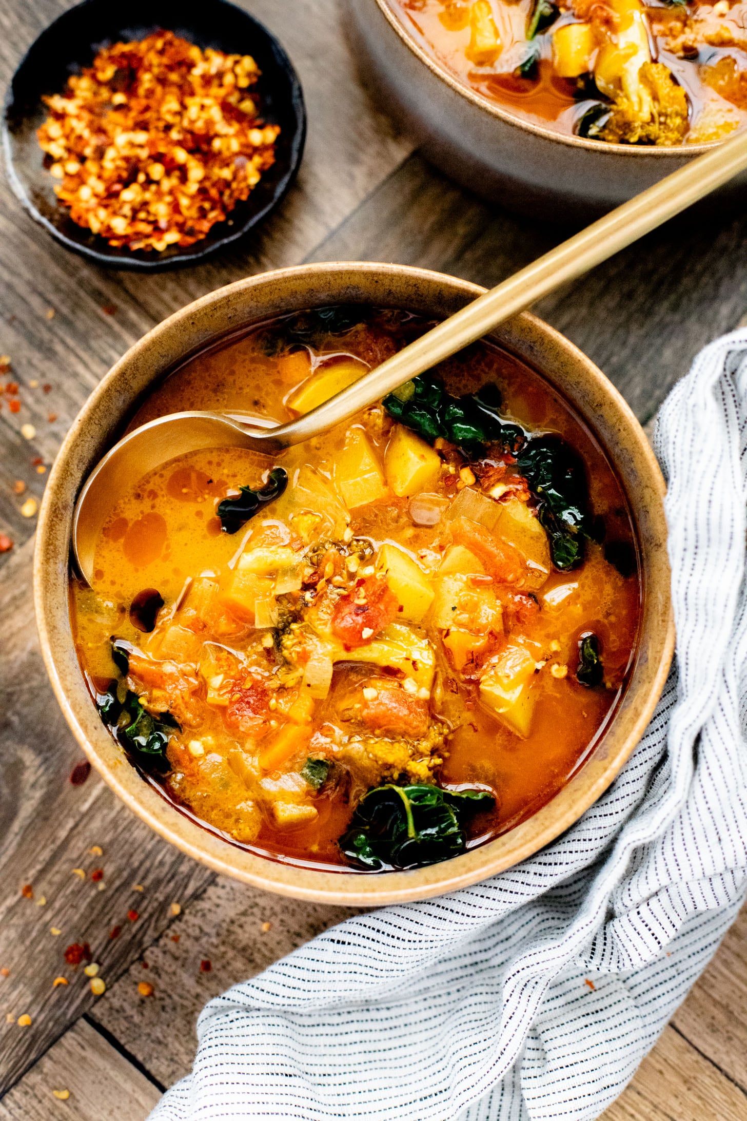 This Slow Cooker Red Curry Potato Soup is packed with veggies and the most delicious coconut broth. The perfect dairy-free soup | ThisSavoryVegan.com