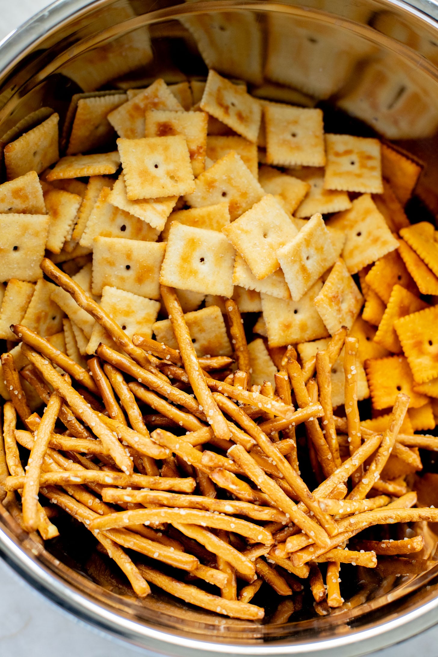 This Vegan Holiday Snack Mix is so addicting. Made with dairy-free cheese crackers, pretzels and the best seasoning blend | ThisSavoryVegan.com